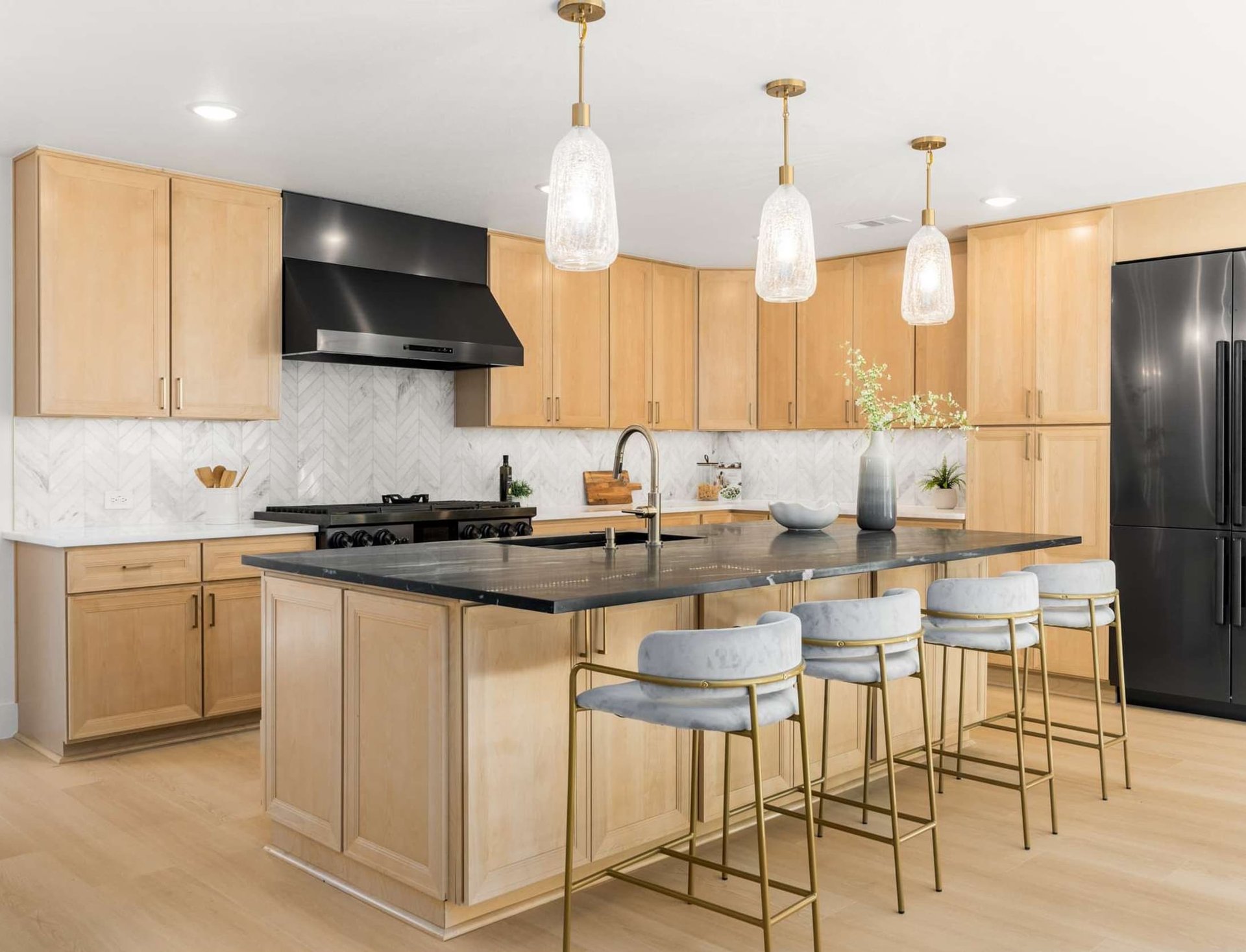 Remodeled kitchen island featuring a black countertop, built by Buffalo Ridge Construction